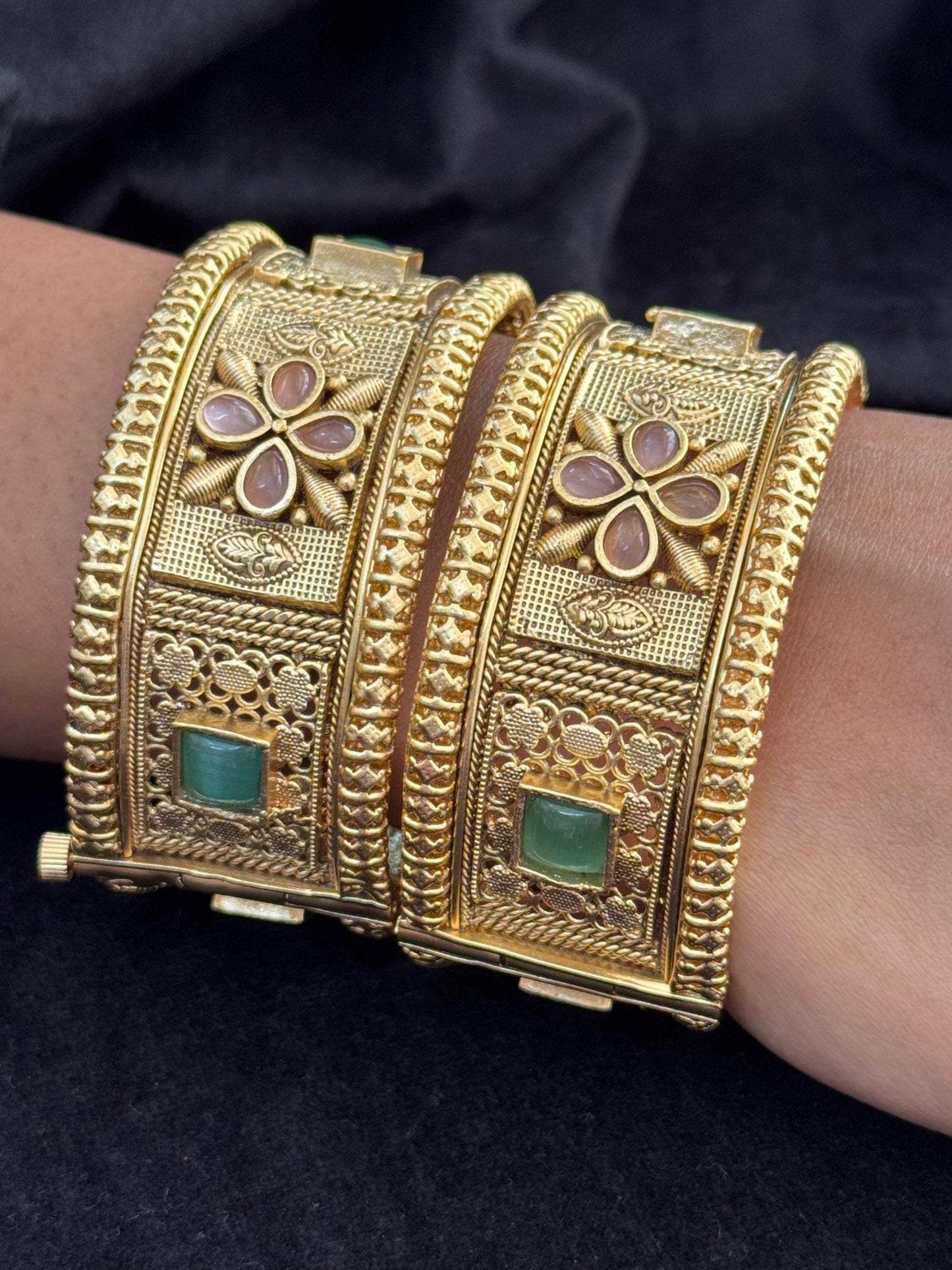 Emerald Bloom Rajwadi Kada - Gold polished bridal kada with floral pastel petal motifs and green square stones in embossed temple styling.