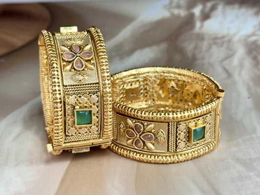 Emerald Bloom Rajwadi Kada - Gold polished bridal kada with floral pastel petal motifs and green square stones in embossed temple styling.