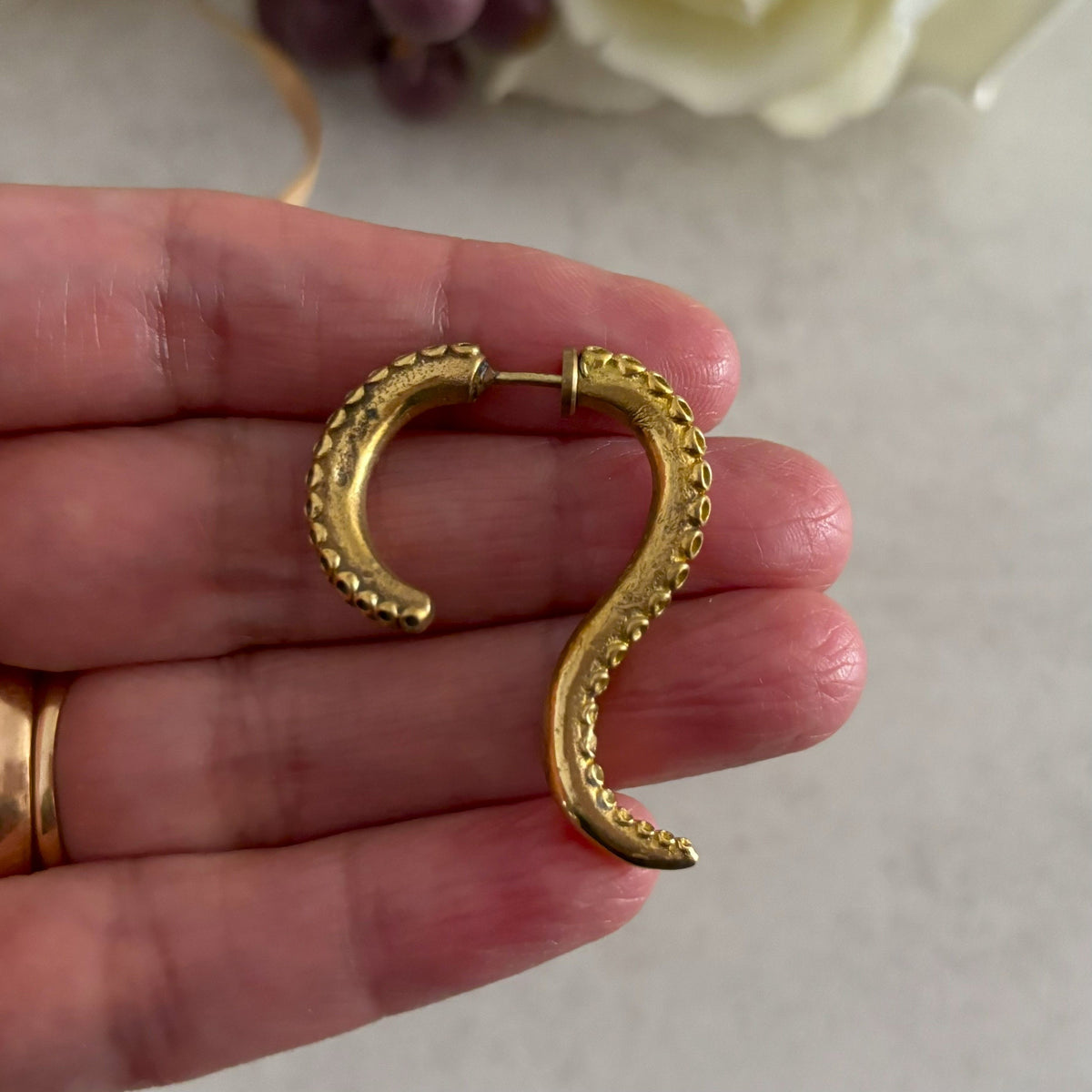 Brass Octopus Tentacle Earrings — Siren Coil held in hand, showing size and dimensions