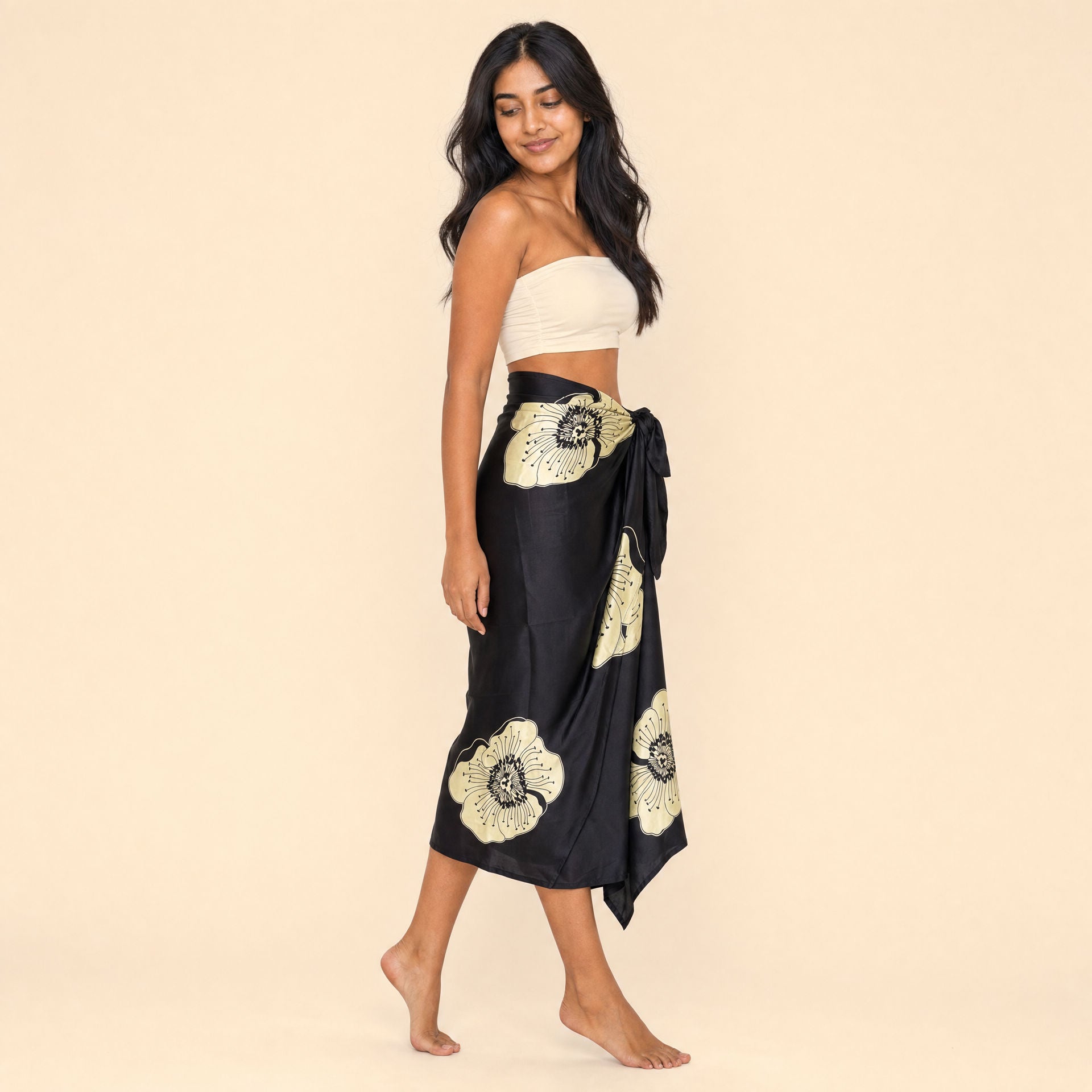 Black floral satin sarong — side profile showing the wrap drape and hip knot