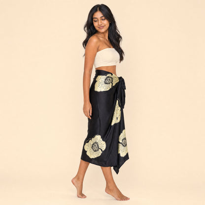 Black floral satin sarong — side profile showing the wrap drape and hip knot