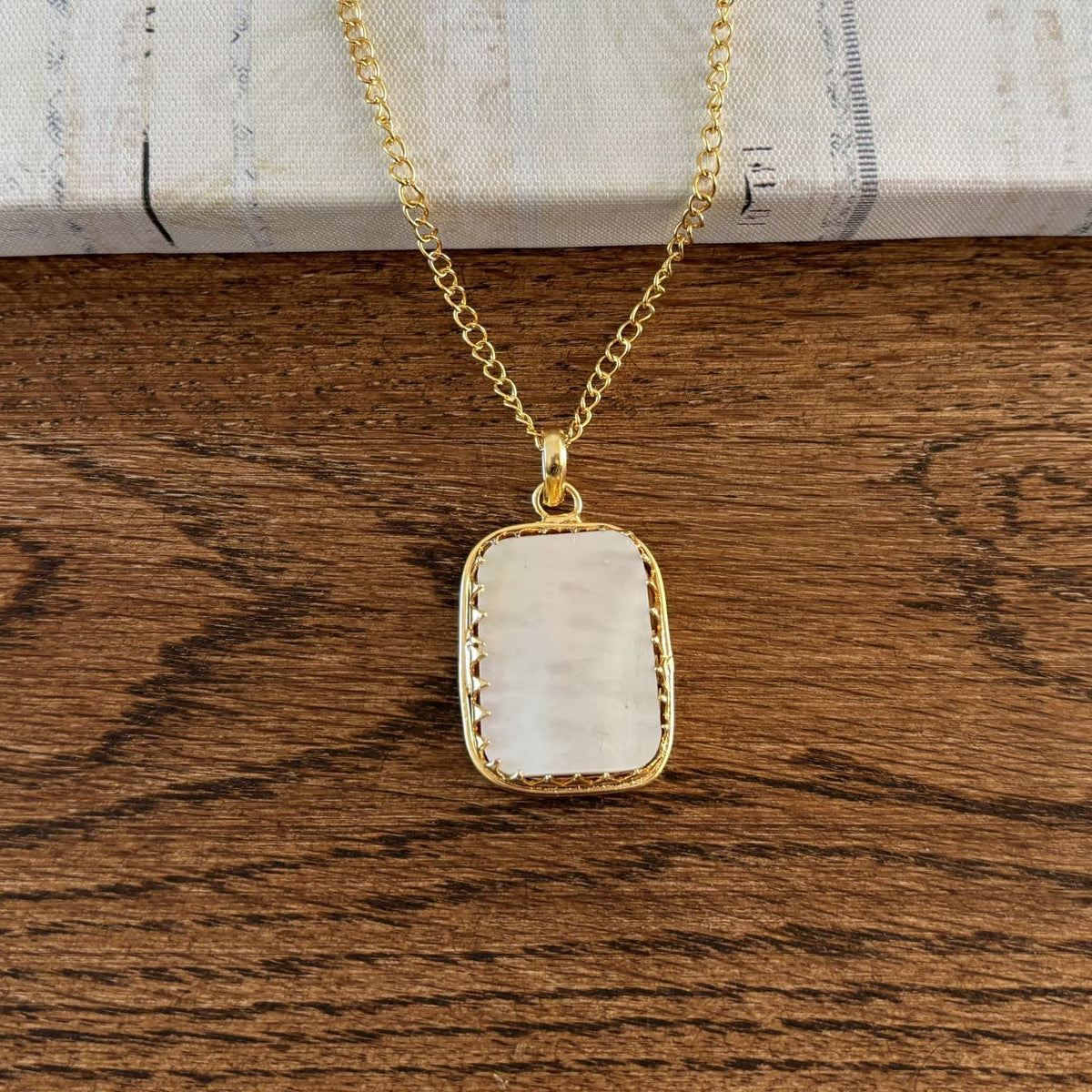 Close-up of the crown bezel and oval bail on the Mother of Pearl Pendant Necklace — Tidal Glow