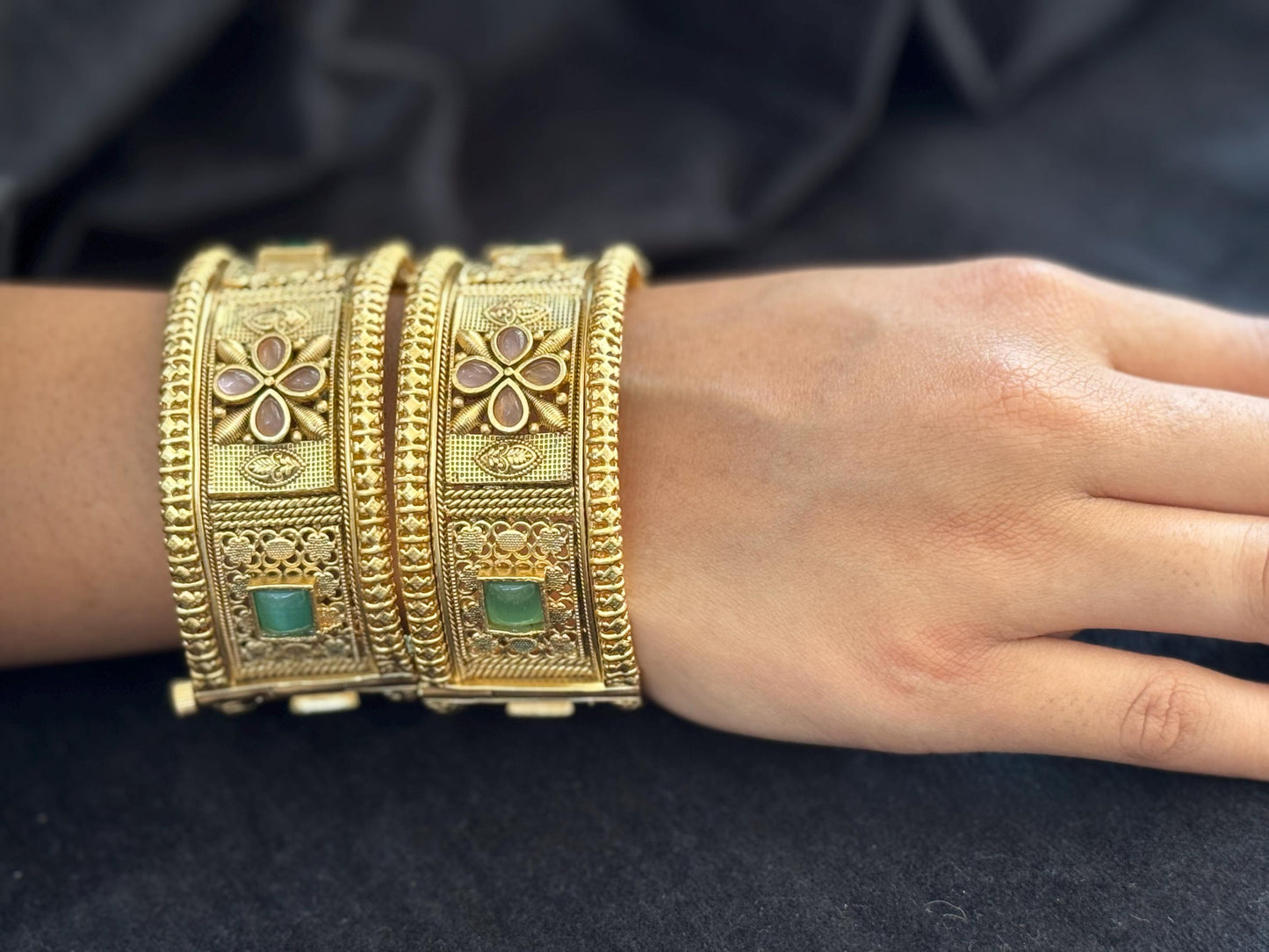 Emerald Bloom Rajwadi Kada - Gold polished bridal kada with floral pastel petal motifs and green square stones in embossed temple styling.