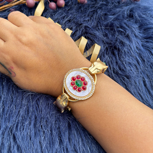 Twin Panther Brass Kada Bangle — Sherni worn on wrist, floral cabochon centre and panther heads
