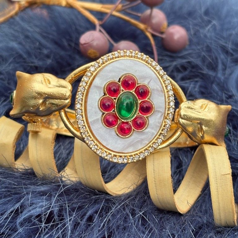 Twin Panther Brass Kada Bangle — Sherni styled close-up of the white marbled panel and panther heads