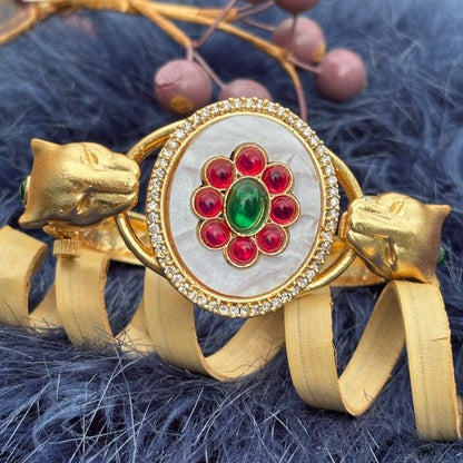 Twin Panther Brass Kada Bangle — Sherni styled close-up of the white marbled panel and panther heads