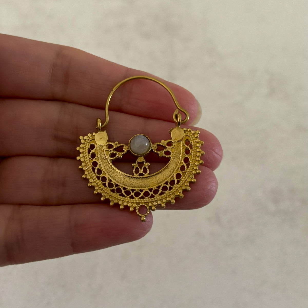 Filigree Brass Crescent Moon Hoop Earrings — Lunar Lace in gold, Small, held in hand to show size