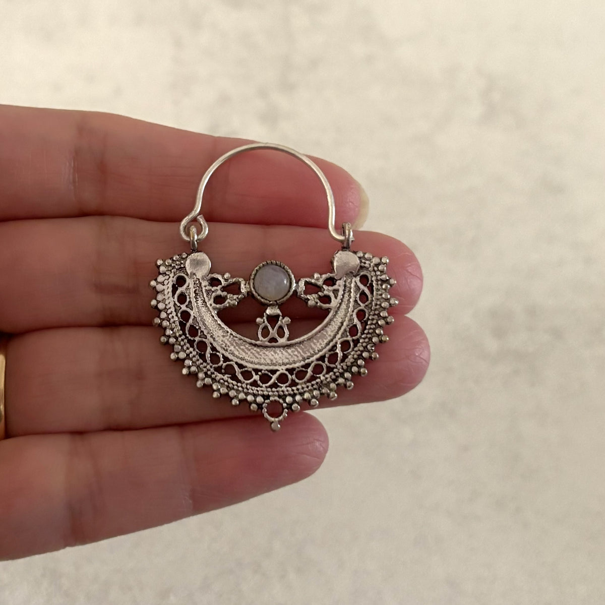 Filigree Brass Crescent Moon Hoop Earrings — Lunar Lace in silver-plated brass, Small, held in hand