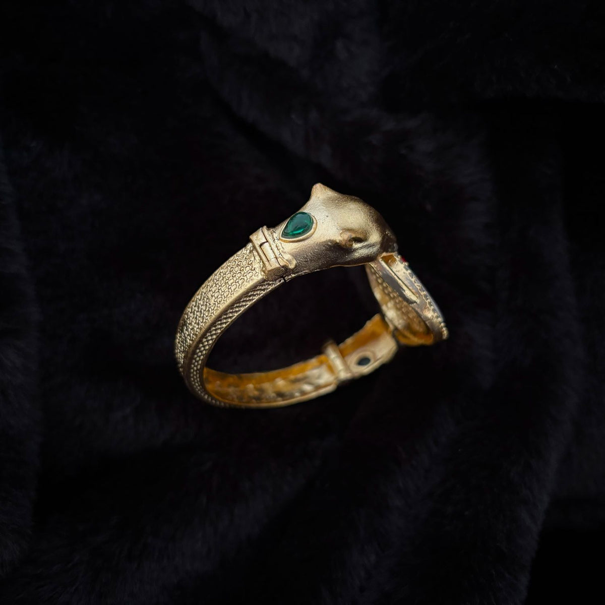 Twin Panther Brass Kada Bangle — Sherni side view showing hinge, textured band and green panther eye-stone