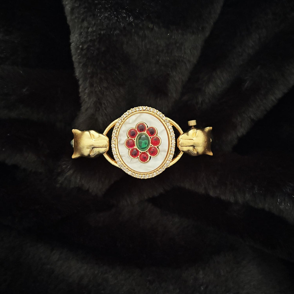 Close-up of floral cabochon centre and twin panther heads on Twin Panther Brass Kada Bangle — Sherni