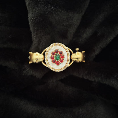 Close-up of floral cabochon centre and twin panther heads on Twin Panther Brass Kada Bangle — Sherni